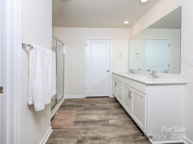 bathroom with vanity, hardwood / wood-style flooring, and walk in shower