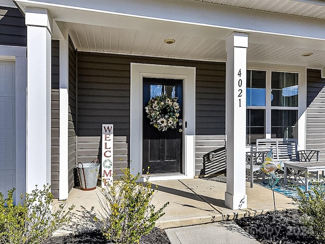 property entrance with covered porch