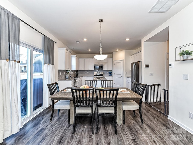 dining room with dark hardwood / wood-style floors and sink