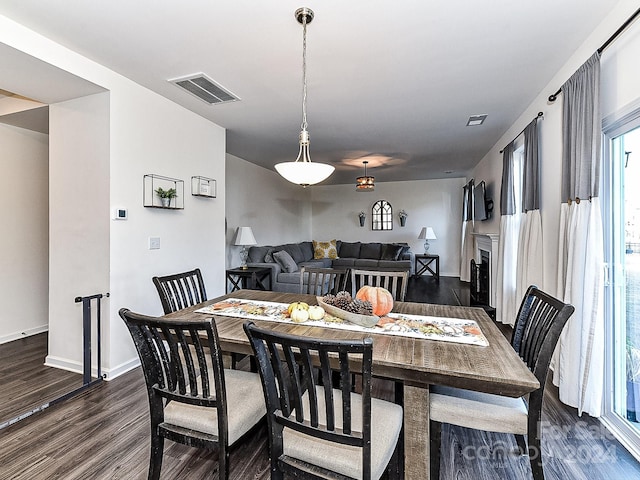 dining space with dark hardwood / wood-style floors