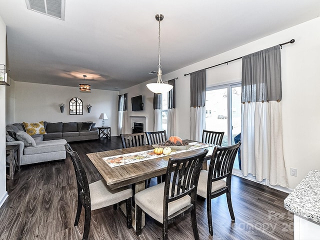 dining space with dark hardwood / wood-style flooring