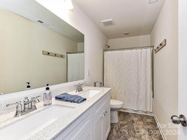 full bathroom featuring shower / bath combination with curtain, vanity, and toilet