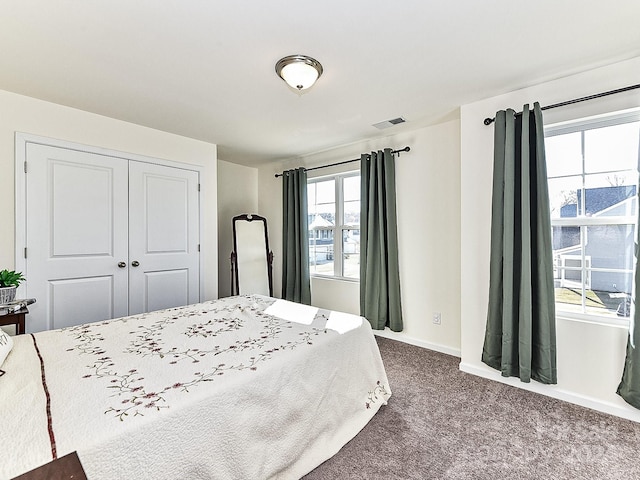 carpeted bedroom with a closet