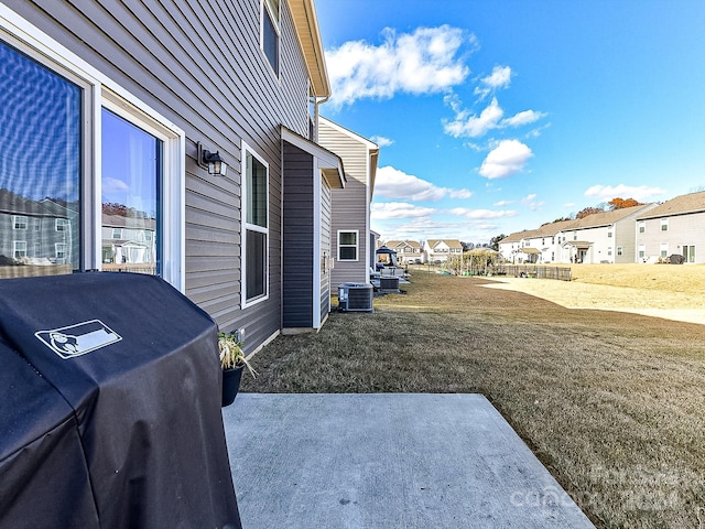 view of home's exterior featuring a yard, a patio area, and central air condition unit