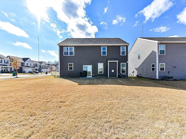 rear view of house featuring a lawn