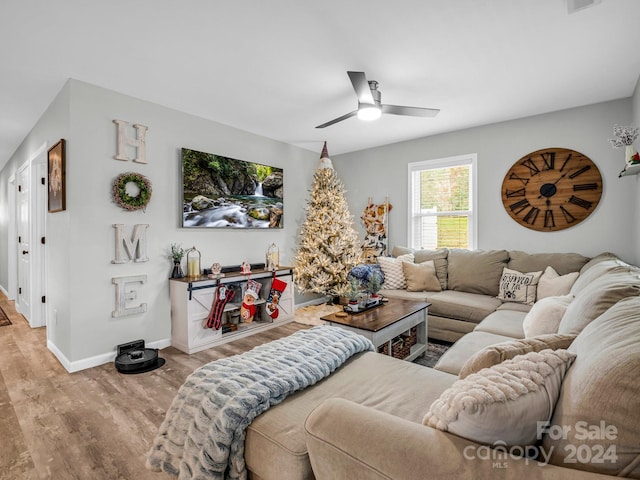 living room with light hardwood / wood-style floors and ceiling fan