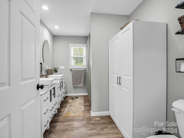 bathroom featuring hardwood / wood-style flooring, vanity, and toilet