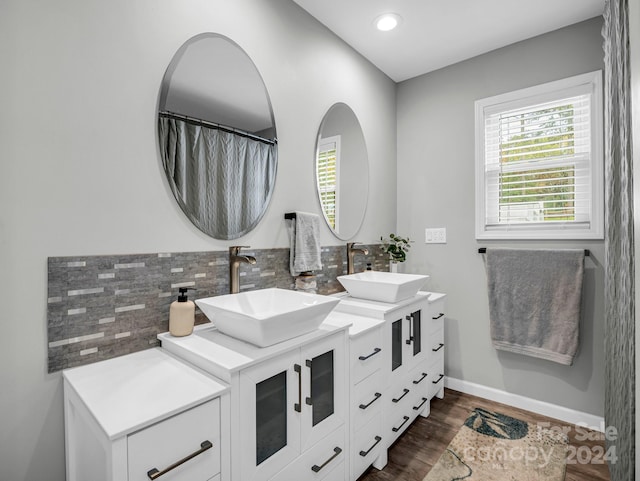 bathroom featuring decorative backsplash, hardwood / wood-style floors, and vanity