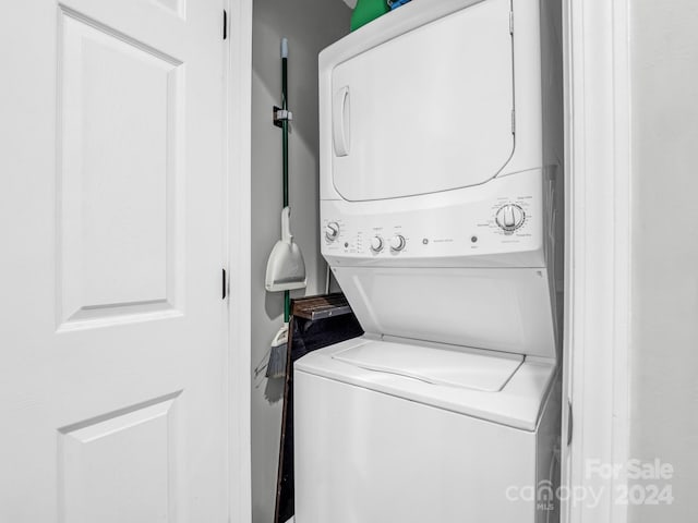 laundry room with stacked washer / dryer