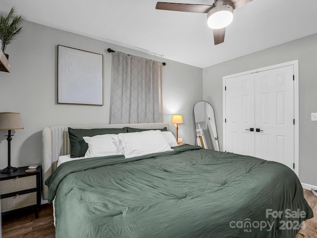 bedroom featuring ceiling fan, wood-type flooring, and a closet