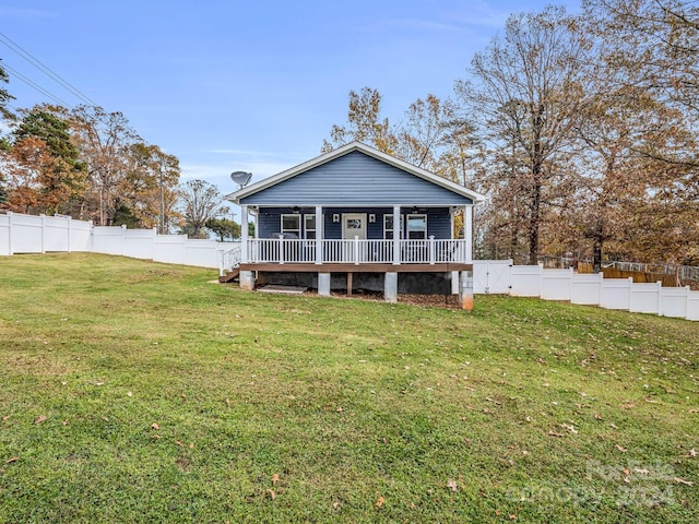 back of house with a lawn