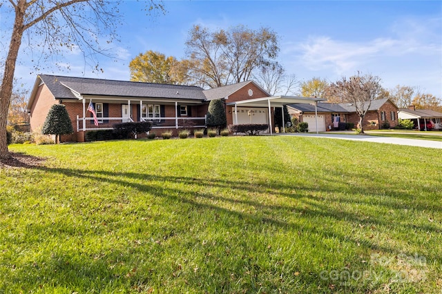 ranch-style house featuring covered porch, a garage, and a front yard