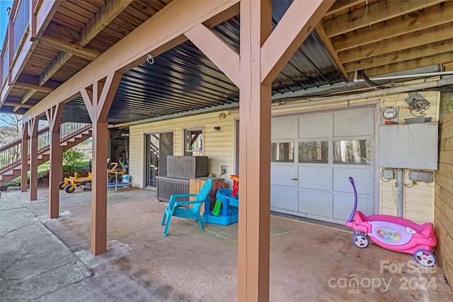 view of patio / terrace featuring a garage