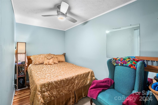 bedroom featuring hardwood / wood-style floors, ceiling fan, crown molding, and a textured ceiling