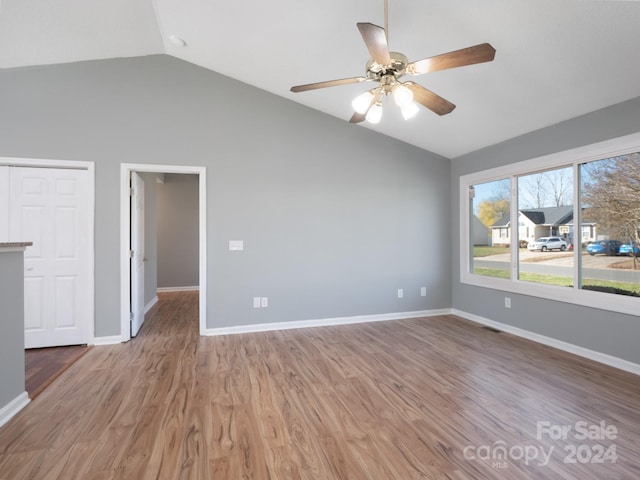 unfurnished room featuring ceiling fan, wood-type flooring, and vaulted ceiling