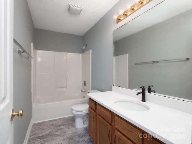 full bathroom with washtub / shower combination, vanity, a textured ceiling, and toilet