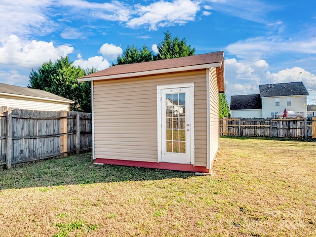 view of outbuilding with a lawn