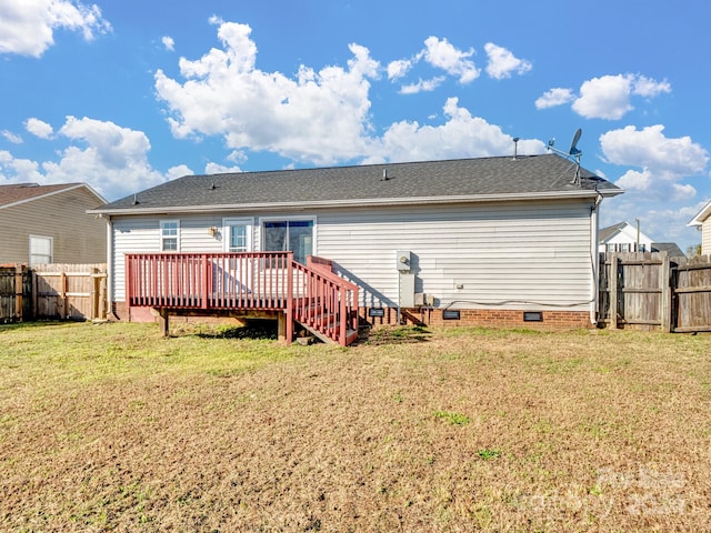 rear view of house featuring a yard and a wooden deck