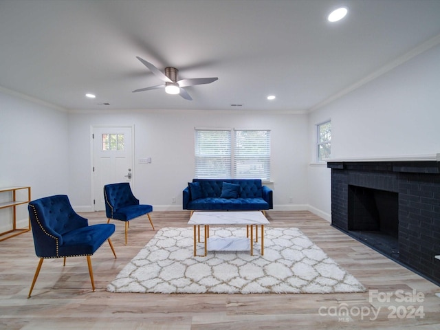 living room with a fireplace, hardwood / wood-style floors, and crown molding