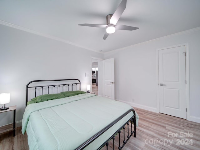 bedroom featuring ceiling fan, ornamental molding, and light wood-type flooring