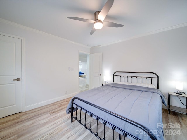 bedroom featuring ceiling fan, light hardwood / wood-style flooring, and ornamental molding