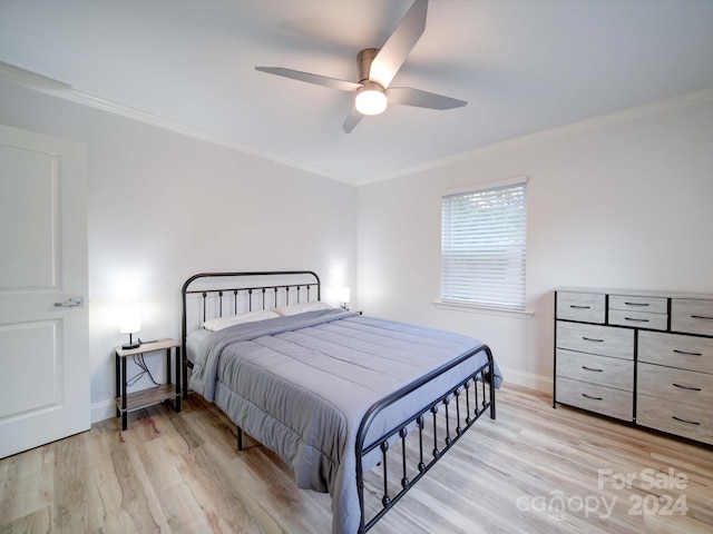 bedroom featuring light wood-type flooring, ceiling fan, and ornamental molding