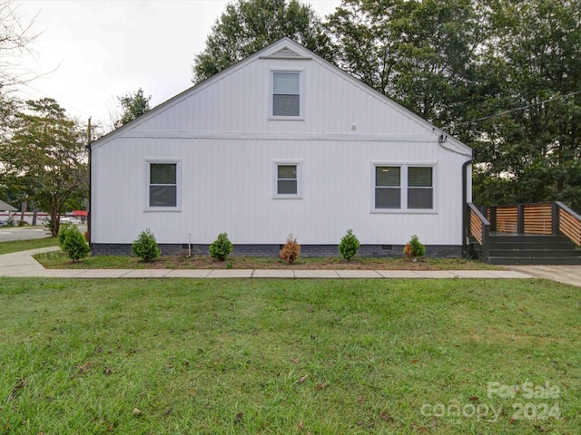 view of home's exterior with a yard