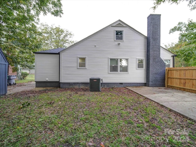 rear view of house featuring central AC