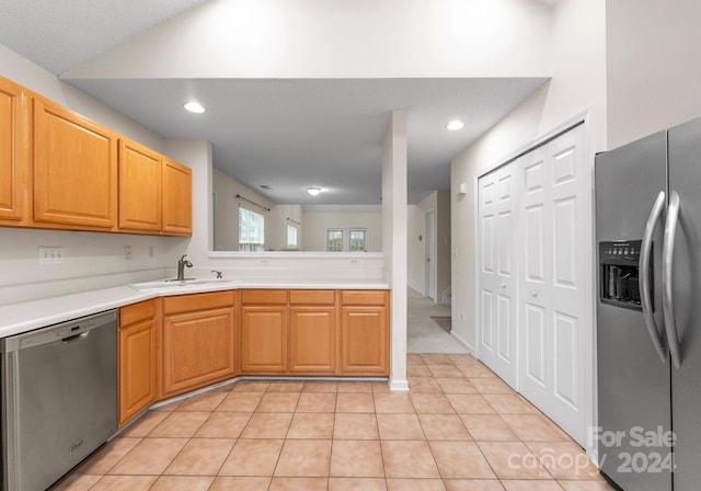 kitchen featuring sink, light tile patterned floors, and appliances with stainless steel finishes