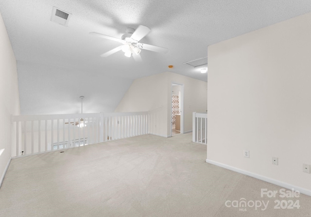 bonus room featuring light carpet, a textured ceiling, ceiling fan, and lofted ceiling