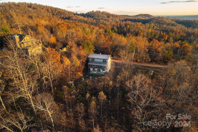 aerial view at dusk featuring a mountain view