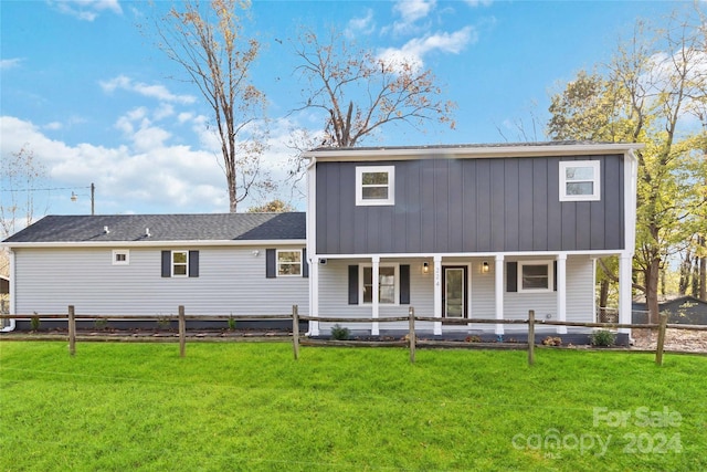 back of house with a porch and a yard