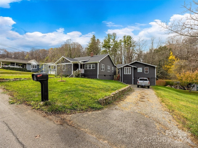 view of front of property featuring a garage and a front lawn