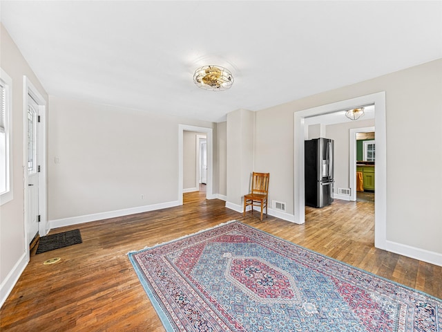 living room with hardwood / wood-style flooring and a notable chandelier