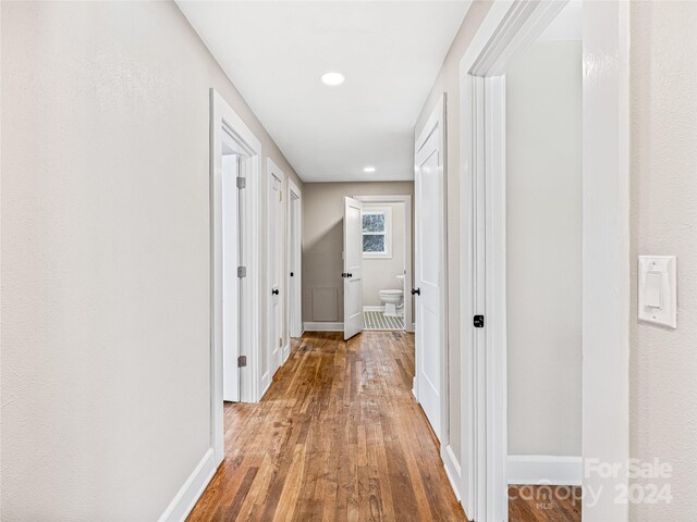 corridor with wood-type flooring