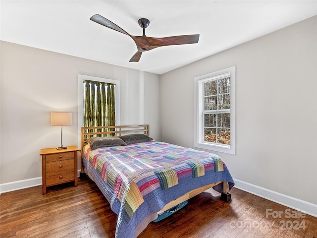 bedroom with ceiling fan and dark wood-type flooring