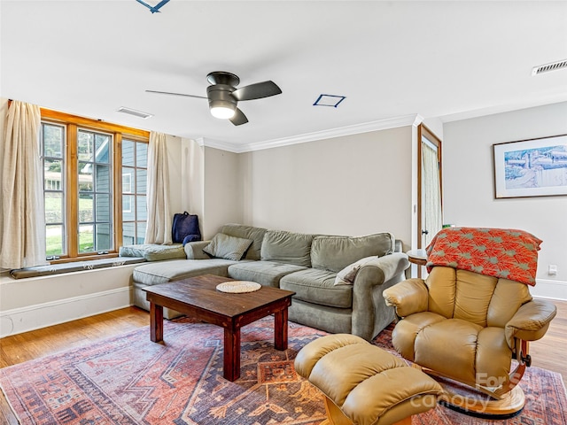 living room with light hardwood / wood-style floors, ceiling fan, and crown molding