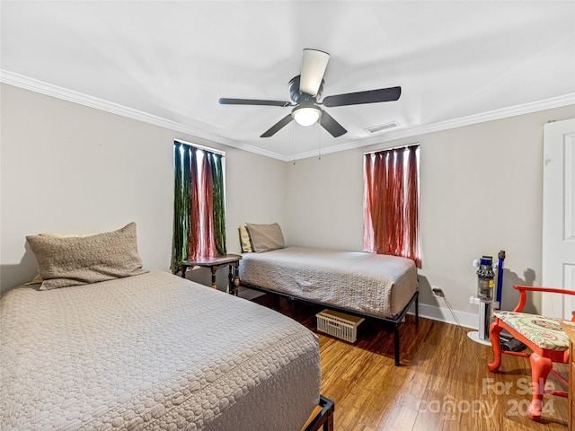 bedroom with ceiling fan, hardwood / wood-style floors, and crown molding