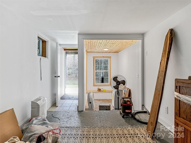 hall featuring wooden ceiling and light tile patterned floors