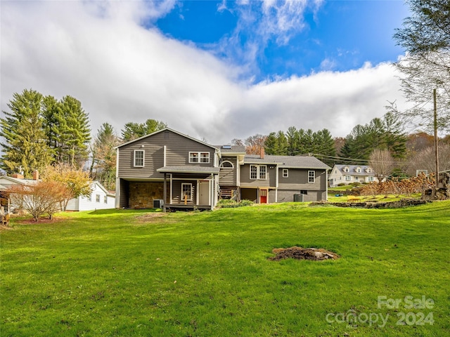 rear view of house with a yard