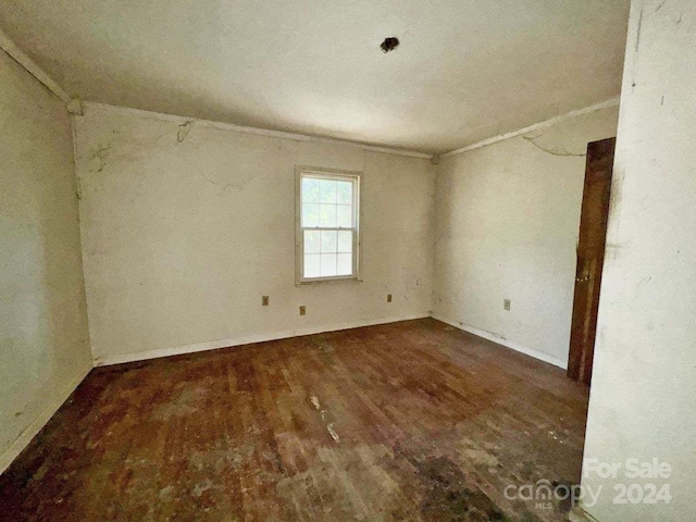 unfurnished room with dark hardwood / wood-style flooring