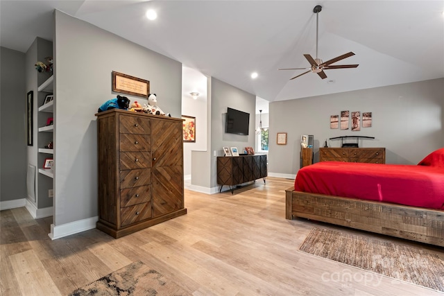 bedroom with light wood-type flooring, vaulted ceiling, and ceiling fan