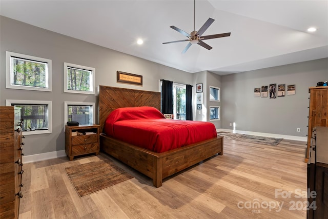 bedroom featuring high vaulted ceiling, light hardwood / wood-style flooring, and ceiling fan