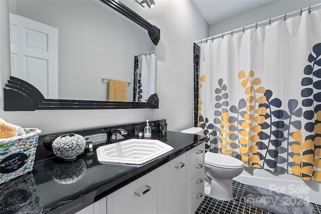 bathroom featuring tile patterned floors, vanity, and toilet