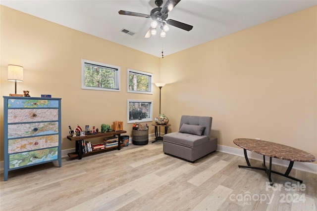 living area with ceiling fan and light wood-type flooring