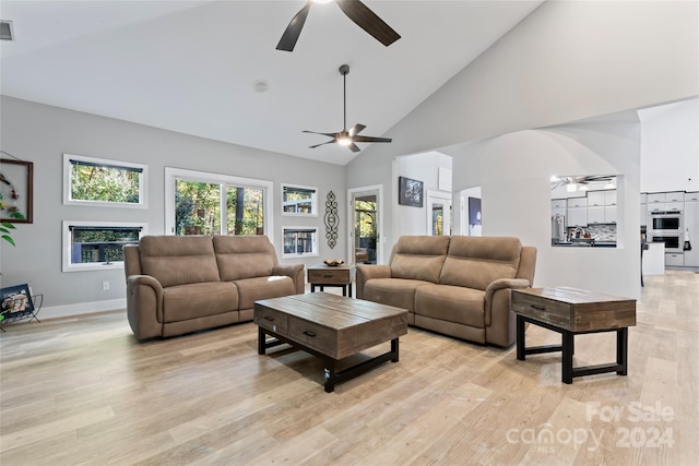 living room with ceiling fan, light wood-type flooring, and high vaulted ceiling