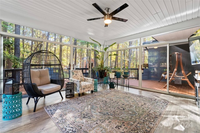 sunroom featuring ceiling fan and wooden ceiling