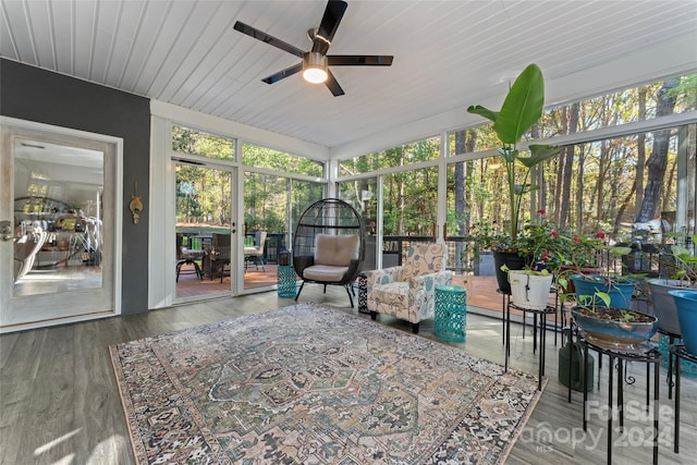 sunroom / solarium with ceiling fan and wooden ceiling