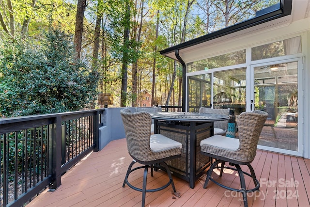 wooden deck featuring a sunroom