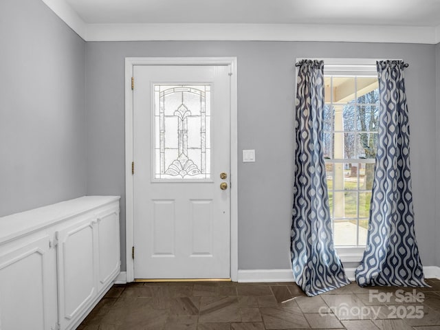 foyer entrance featuring baseboards